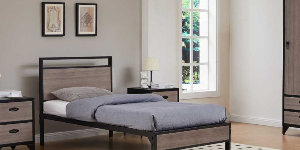 A cozy bedroom with a comfortable bed, a stylish dresser, and a nightstand for convenience.