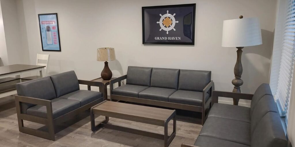 A spacious living room featuring antimicrobial couches and a seamless table, designed for improved hygiene and easy cleaning.