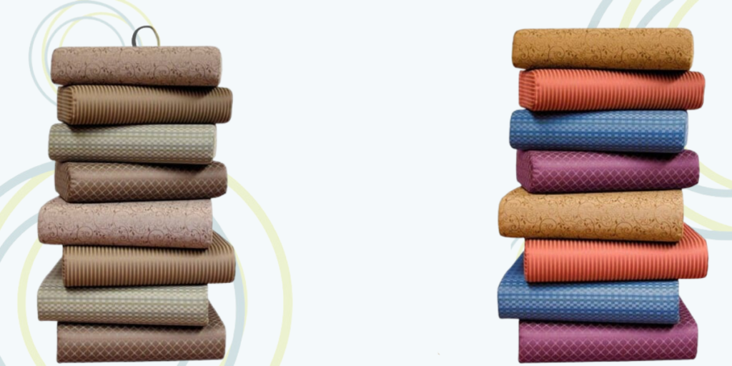 A stack of colorful blankets and pillows arranged neatly, showcasing a variety of textures and hues for comfort and style.