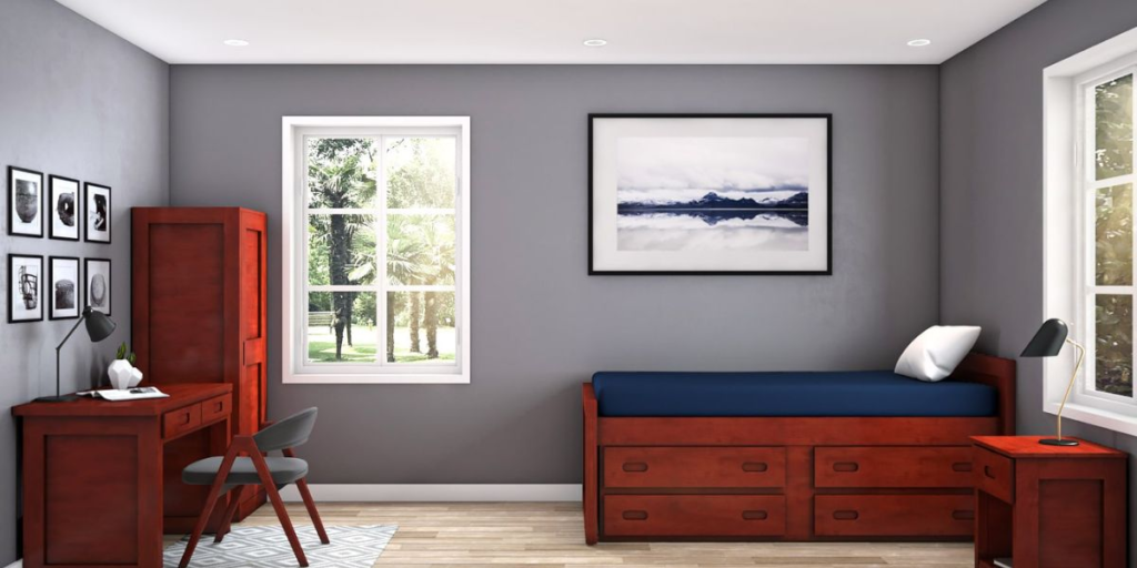 A cozy bedroom featuring a bed, desk, and drawers, designed with sustainable wooden furniture for eco-friendly living.