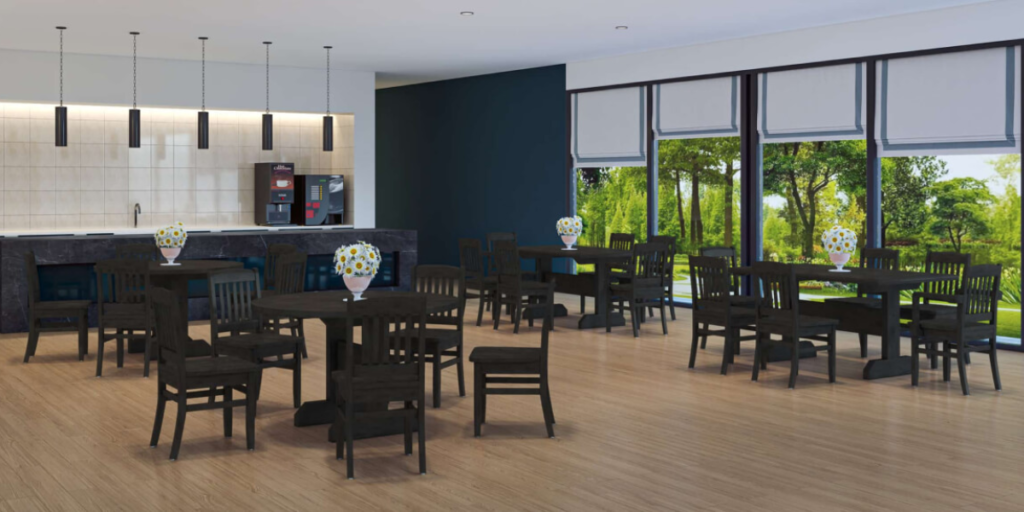 A restaurant interior featuring tables and chairs arranged near large windows, creating a bright and inviting atmosphere.