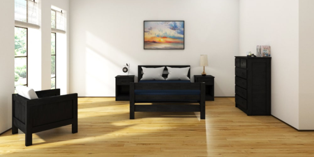 A cozy bedroom featuring a bed, dresser, and chair, designed for comfort and functionality in healthcare settings.