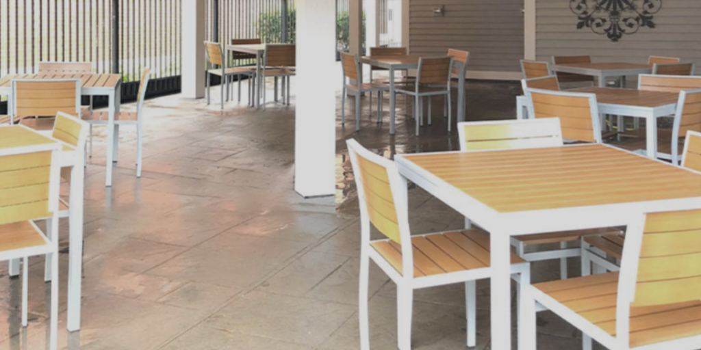 A restaurant featuring tables and chairs positioned in front of a sliding door, creating an inviting dining atmosphere.