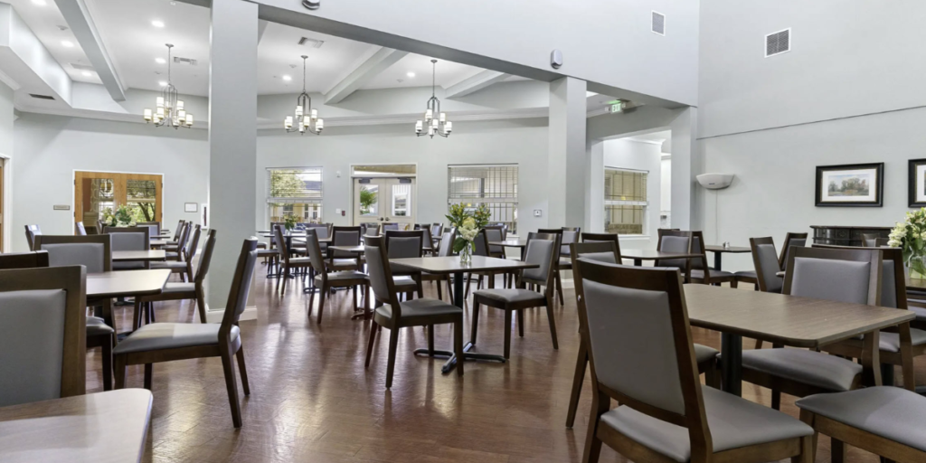 Dining room in a senior living community, featuring inclusive furniture designed for comfort and accessibility for all residents.