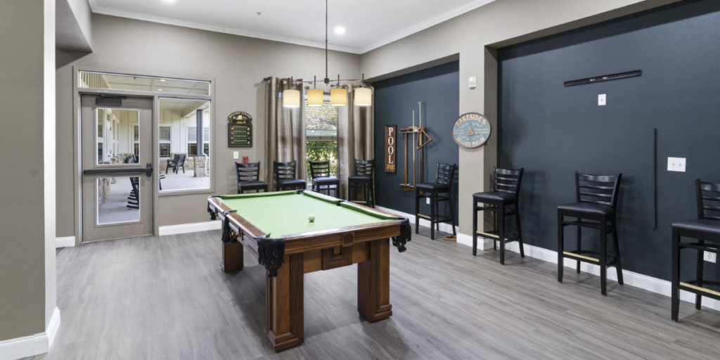 A billiard and pool table in a game room, showcasing a space for leisure and recreation.