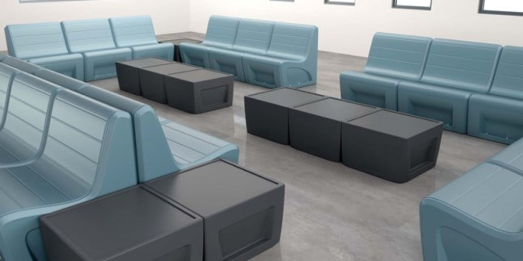 A spacious room featuring blue seating and black cube-shaped furniture, creating a modern and inviting atmosphere.
