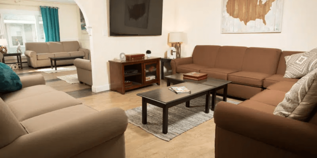 A cozy living room featuring comfortable couches, chairs, and a television for relaxation and entertainment.