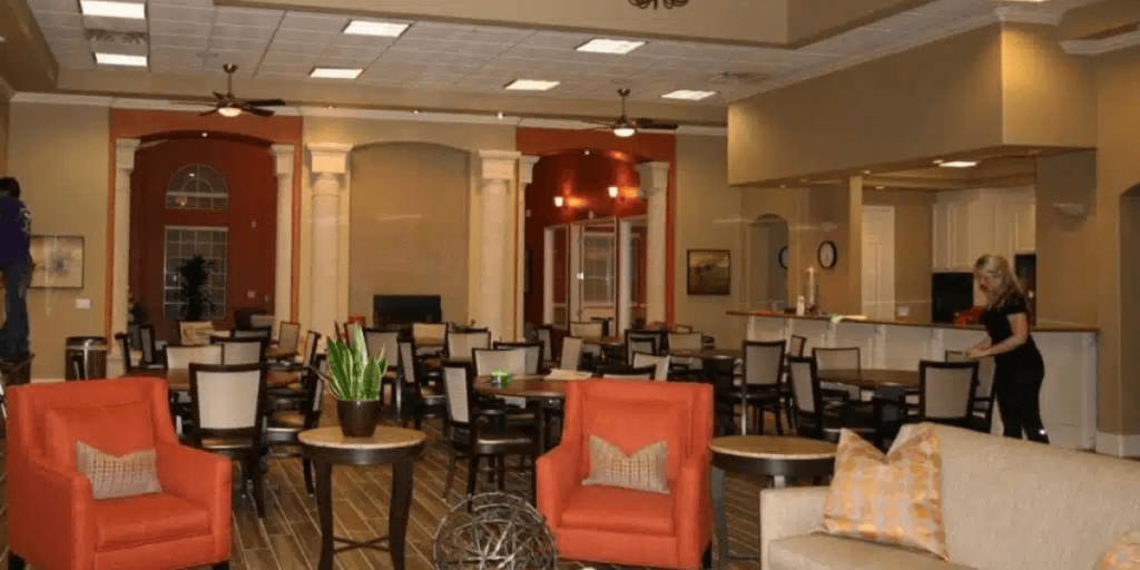 The hotel lobby features a spacious dining area with elegant furnishings and a welcoming atmosphere for guests.