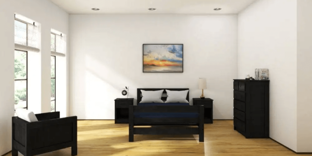 A cozy bedroom featuring a neatly made bed, a wooden dresser, and a comfortable chair in a well-lit space.