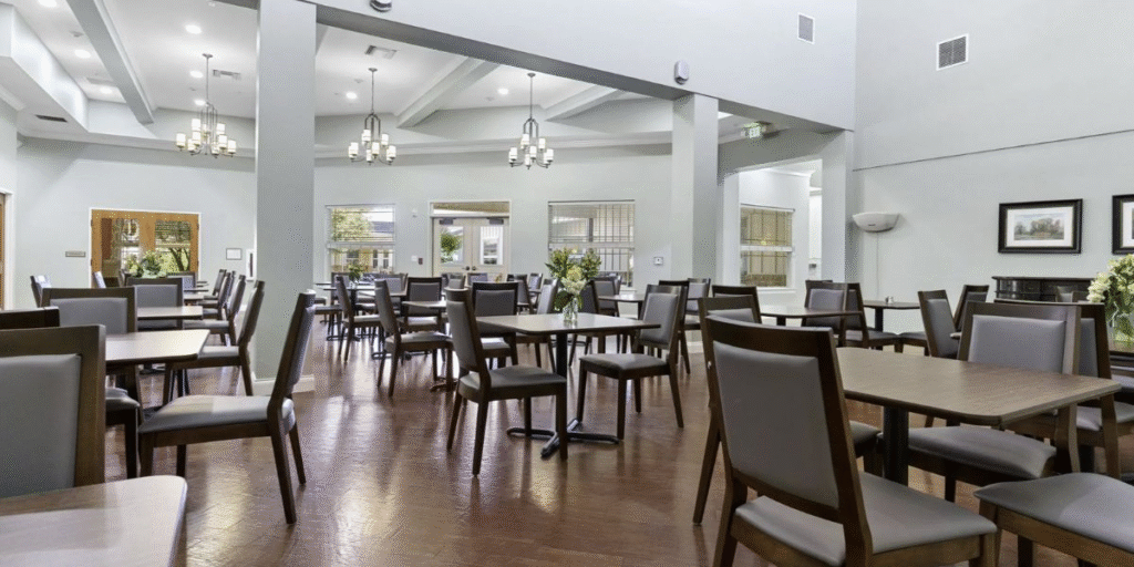 Dining room in a senior living community featuring durable, heavy-duty furniture designed for constant use and high traffic.