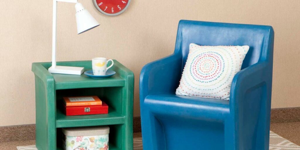 A blue chair and a green chair are positioned next to a wall clock, highlighting a flexible and safe furniture arrangement.