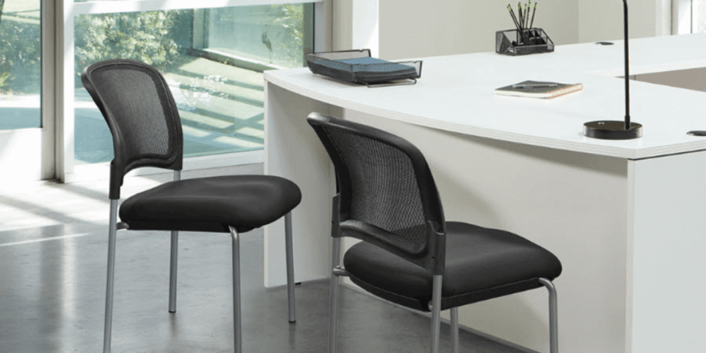 Modern office reception area featuring two inviting chairs and a desk, designed to create a welcoming atmosphere for clients.