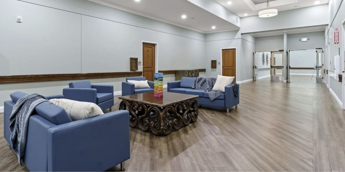 Living room at the community center featuring calming earth tones and comfortable furniture, promoting a soothing atmosphere.